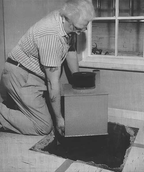 man installing underfloor safe